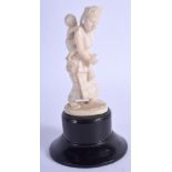 AN EARLY 20TH CENTURY INDIAN CARVED IVORY FIGURE, formed as a mother and child. Total heigh 11.5 cm.