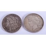 A LIBERTY 1928 SILVER COIN together with another silver dollar. (2)