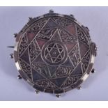 AN ISLAMIC MIDDLE EASTERN SILVER COIN BROOCH. 3.5 cm diameter.