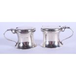 A PAIR OF SILVER SALTS. 2 oz. 6 cm wide.