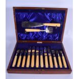 A CASED SET OF ANTIQUE CARVED IVORY AND SILVER BLADED CUTLERY. (qty)