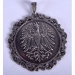 AN ANTIQUE SILVER EAGLE MEDALLION. 4 cm x 4 cm.