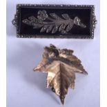 AN ART DECO SILVER BROOCH and a leaf brooch. (2)