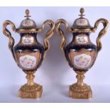 A LARGE PAIR OF TWIN HANDLED SEVRES PORCELAIN VASE, decorated with cherubs. 58 cm high.