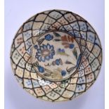 A MIDDLE EASTERN POTTERY DISH, decorated with foliage. 21.5 cm wide.