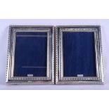 A PAIR OF STERLING SILVER PHOTOGRAPH FRAMES. 16 cm x 21 cm.