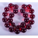 A CHERRY AMBER TYPE NECKLACE. 41 cm long.