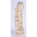 A FINE 19TH CENTURY JAPANESE MEIJI PERIOD CARVED IVORY OKIMONO modelled as a female holding a bird.