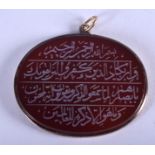 AN ISLAMIC CARVED AGATE CALLIGRAPHY PENDANT. 4.5 cm x 4 cm.