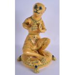 A LARGE EARLY 20TH CENTURY CONTINENTAL YELLOW GLAZED FAIENCE MONKEY modelled playing a tambourine. 4