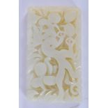 A CHINESE WHITE JADE PLAQUE, carved with a mythical beast amongst foliage. 8.75 cm x 5 cm.