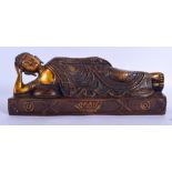 A CHINESE BRONZE FIGURE OF A LYING BUDDHA. 30 cm wide.