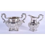 A VICTORIAN IRISH SILVER CREAM JUG and sugar basin. Dublin 1844 & 1847. 23.6 oz. (2)