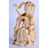 A JAPANESE MEIJI PERIOD IVORY OKIMONO, formed as a seated female. 12 cm high.