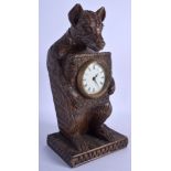 A WOODEN MANTEL CLOCK IN THE FORM OF A BEAR. 31 cm high.