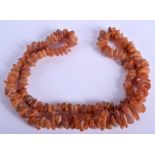 AN EARLY 20TH CENTURY AMBER NECKLACE. 80 cm long.
