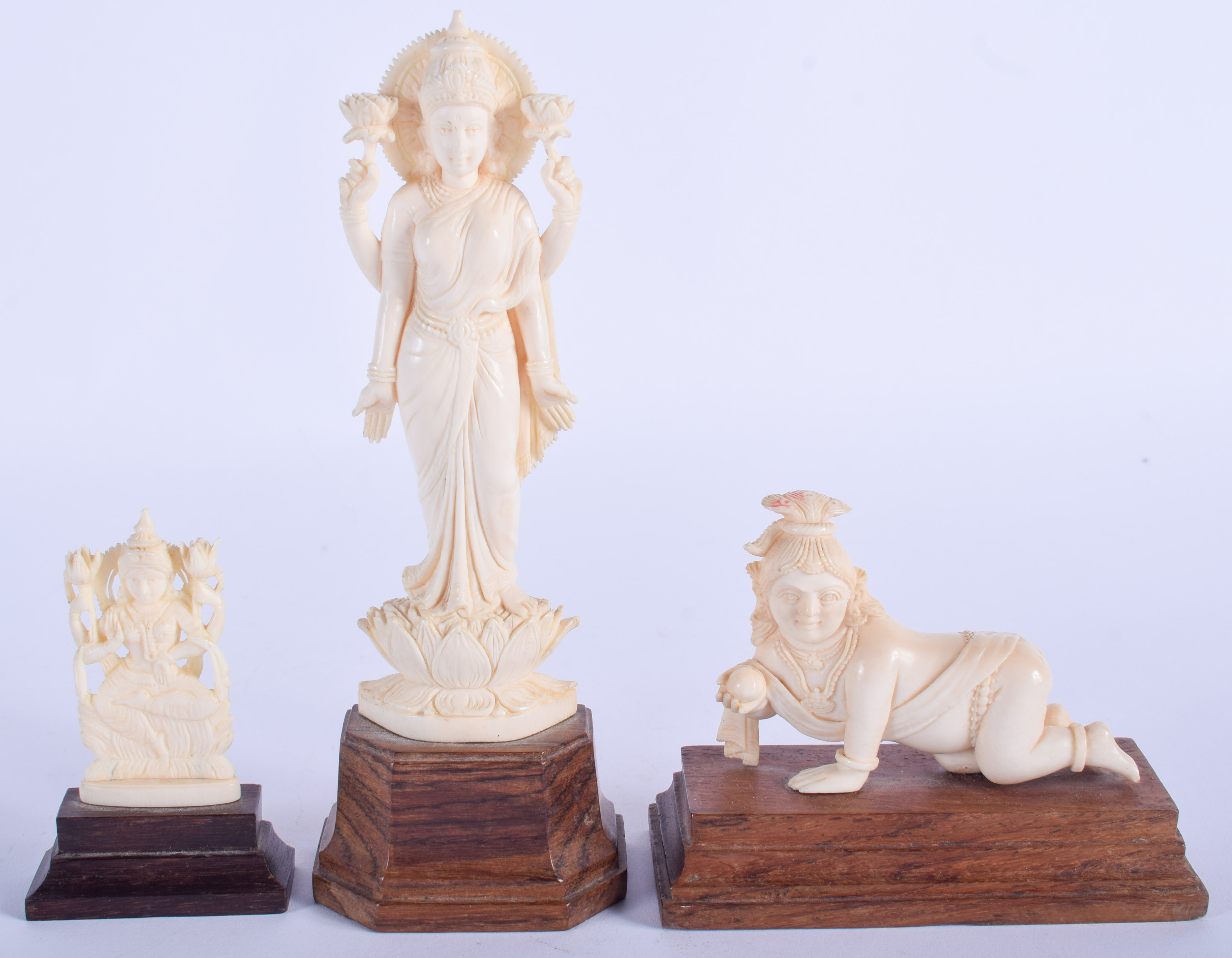 THREE 19TH CENTURY ANGLO INDIAN CARVED IVORY FIGURES in various forms and sizes. Largest 17 cm high.