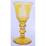 A FINE 18TH/19TH CENTURY BOHEMIAN AMBER GLASS GOBLET wonderfully carved with figures within landscap