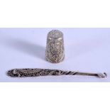 A SILVER THIMBLE and a silver button hook. (2)