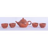 A VINTAGE CHINESE YIXING POTTERY TEAPOT together with four bowls. (5)