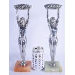 A LARGE PAIR OF ART DECO CHROME FIGURE OF NUDE DANCERS modelled holding aloft floral wreaths. 36 cm