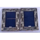 A PAIR OF STERLING SILVER PHOTOGRAPH FRAMES. 14 cm x 18 cm.