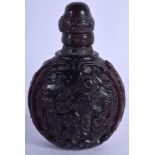 AN EARLY 20TH CENTURY CHINESE BUFFALO HORN SNUFF BOTTLE, carved with roaming horses in a landscape,