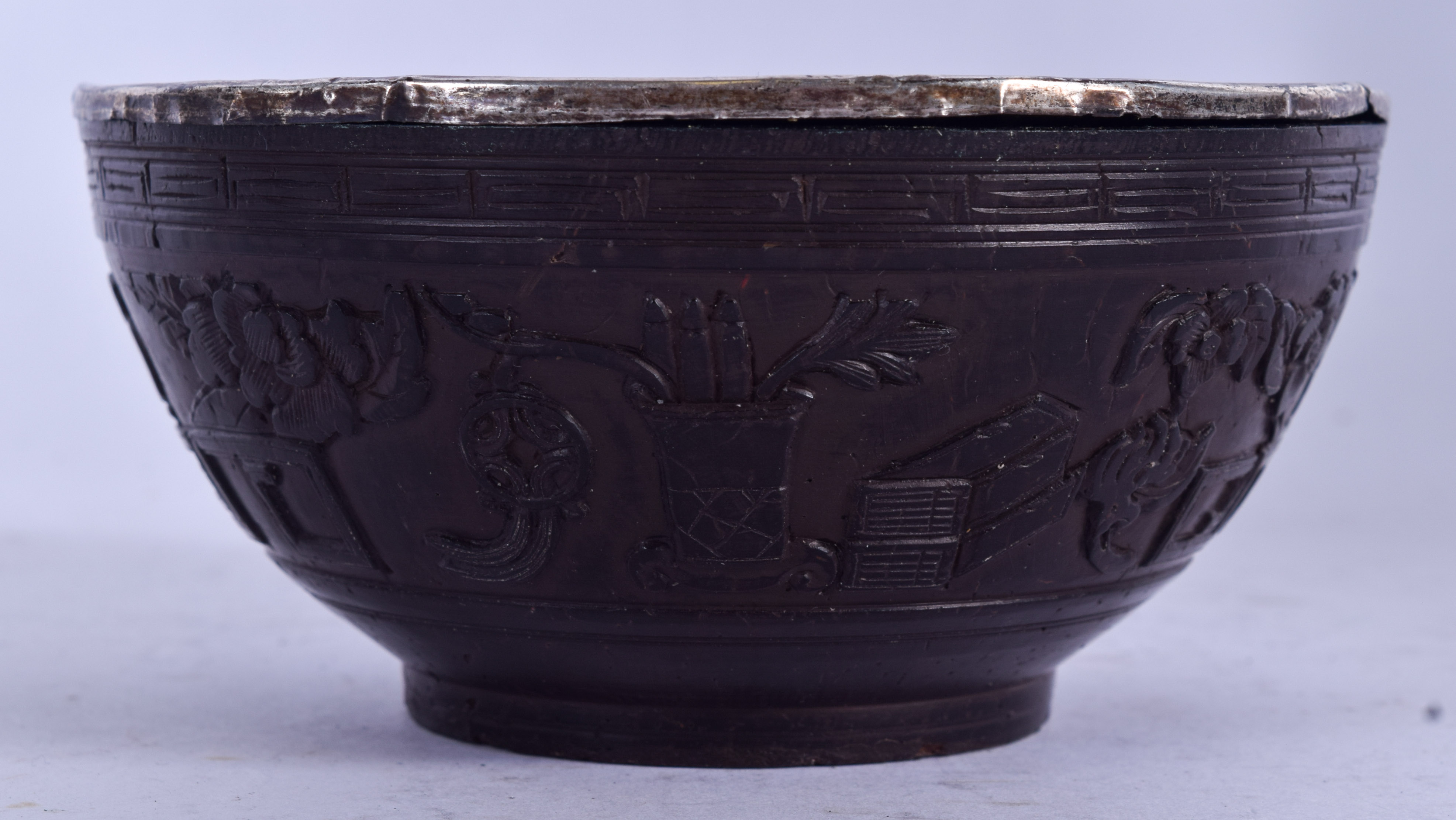 A CHINESE QING DYNASTY COCONUT SHELL BOWL, carved witrh precious objects. 11 cm wide.