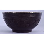 A CHINESE QING DYNASTY COCONUT SHELL BOWL, carved witrh precious objects. 11 cm wide.