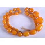 AN AMBER NECKLACE. 86 grams. 60 cm long. Largest bead 3 cm wide.