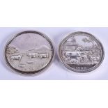 TWO VICTORIAN SILVER RURAL PLOUGHING COW MEDALLIONS. (2)