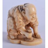 A FINE 19TH CENTURY JAPANESE MEIJI PERIOD CARVED IVORY NETSUKE modelled as male pulling roots. 4 cm