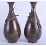 A PAIR OF 19TH CENTURY JAPANESE MEIJI PERIOD BRONZE VASES overlaid with birds viewing a spider. 27 c