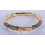 A CHINESE YELLOW METAL MOUNTED HARDSTONE BANGLE. 7.5 cm wide.