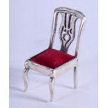 A SMALL SILVER CHAIR. 2.5 cm high.