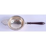 AN ENGLISH SILVER TEA STRAINER. 17 cm long.