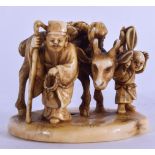 A 19TH CENTURY JAPANESE MEIJI PERIOD CARVED IVORY OKIMONO modelled as figures beside a deer. 6 cm x