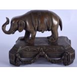 AN 18TH CENTURY EUROPEAN BRONZE MODEL OF AN ELEPHANT modelled upon a canted base. 12 cm x 10 cm.