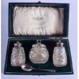 A SILVER AND GLASS CONDIMENT SET. (4)