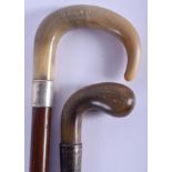 A 19TH CENTURY CARVED RHINOCEROS HORN HANDLED CANE together with a buffalo horn stick. 88 cm long. (