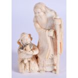 A 19TH CENTURY JAPANESE MEIJI PERIOD CARVED IVORY OKIMONO modelled as two males. 9 cm x 6 cm.