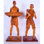 A LARGE PAIR OF AFRICAN FIGURES, formed holding baskets. Largest 46 cm.