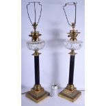 A LARGE PAIR OF EDWARDIAN BRONZE AND CRYSTAL GLASS LAMPS upon stepped bases. 62 cm high not inc fitt