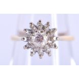 AN 18CT GOLD AND DIAMOND CLUSTER RING. 3 grams. J.