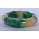 A CHINESE IMITATION BAMBOO TWO TONE JADE BANGLE. 8 cm wide.