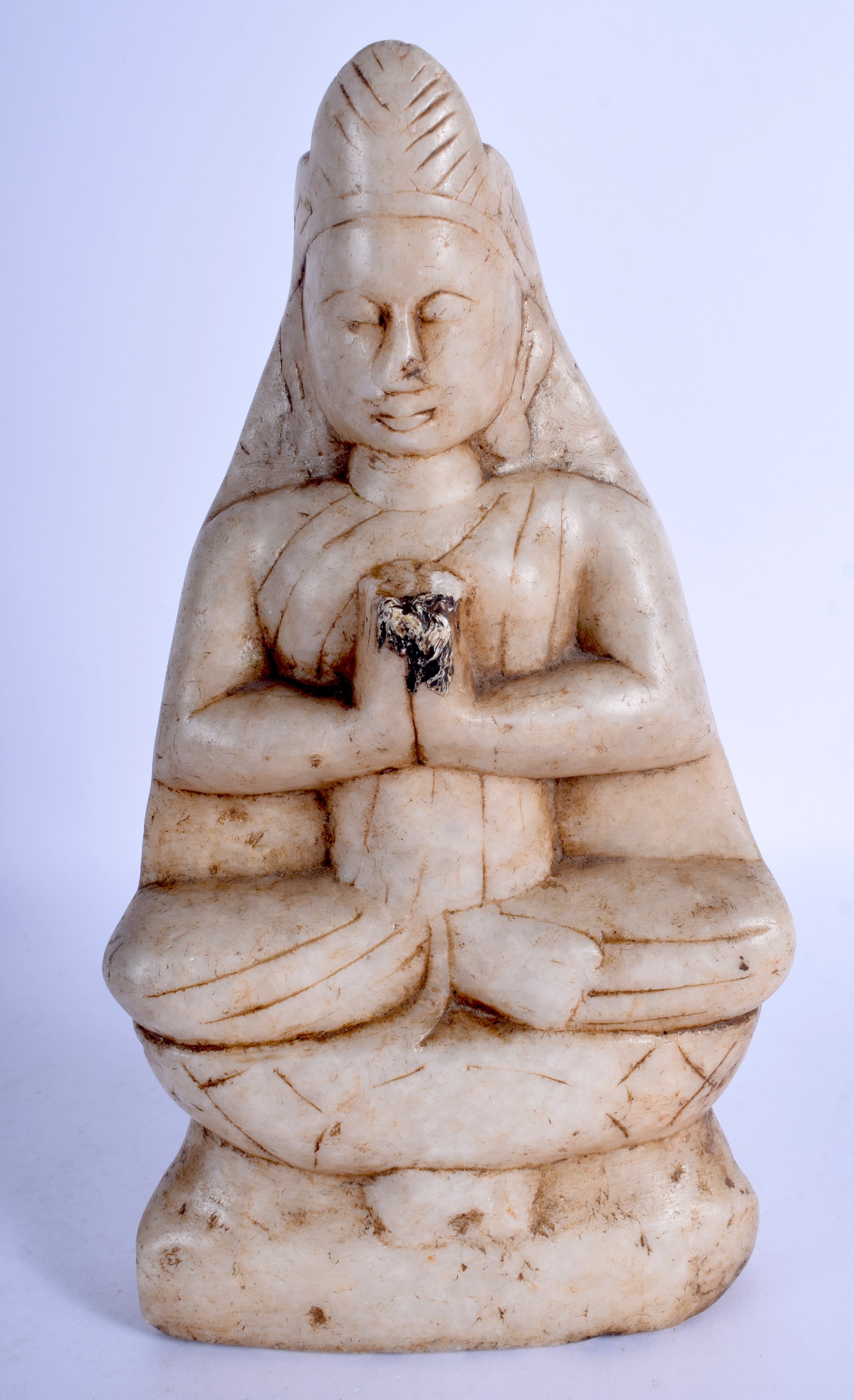 AN 18TH/19TH CENTURY INDIAN ASIAN CARVED MARBLE FIGURE OF A BUDDHISTIC DEITY modelled seated. 26 cm