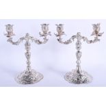A GOOD PAIR OF 19TH CENTURY CONTINENTAL SILVER CANDLEABRA decorated with flowers. 61 oz. 27 cm x 17