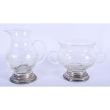 A SILVER MOUNNTED JUG and matching cup. (2)