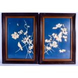 A PAIR OF 19TH CENTURY JAPANESE MEIJI PERIOD CARVED IVORY PANELS depicting birds amognst foliage. 56
