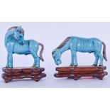 A PAIR OF CHINESE BLUE GLAZED PORCELAIN HORSES, with fitted stands. Largest 9 cmwide. (2)